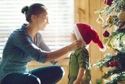 Mother-putting-santa-hat-on-child