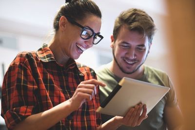 Colleagues-smiling-browsing-tablet-device