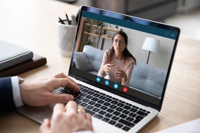 Screen-computer-view-focused-woman-holding-business-negotiations-video-call.